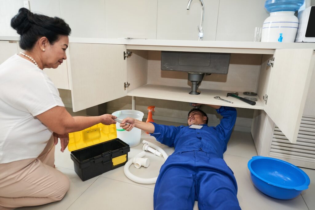 Plumber providing drain cleaning